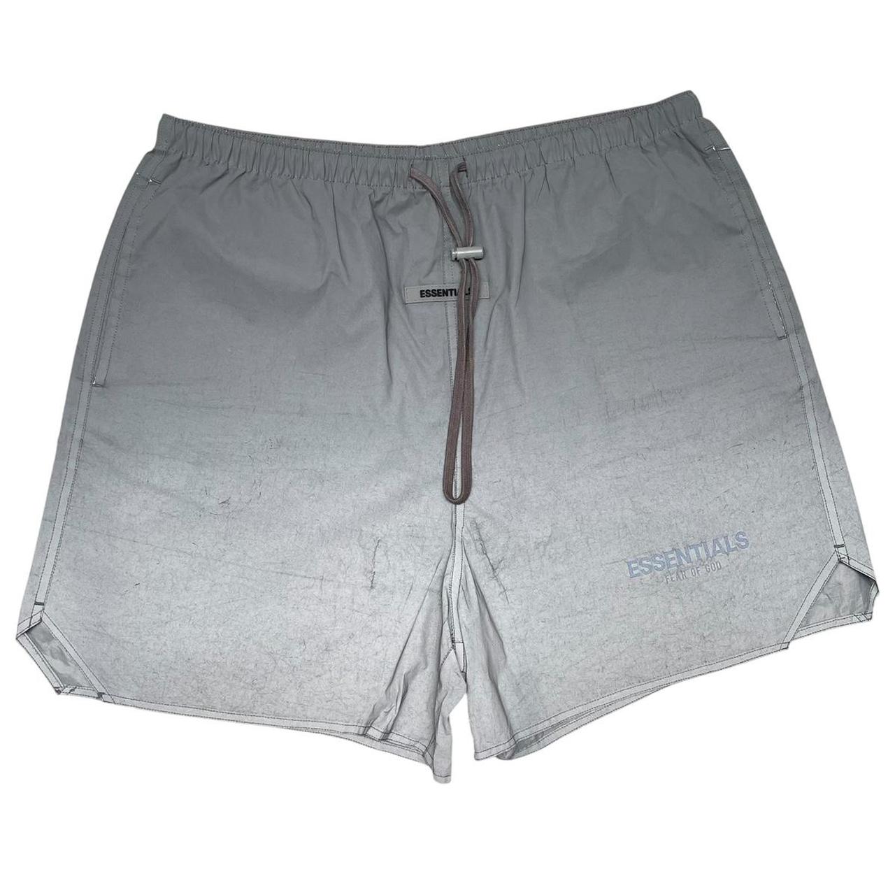 Essentials silver reflective nylon shorts with logo detail and sleek design.