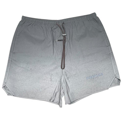 Essentials silver reflective nylon shorts with logo detail and sleek design.