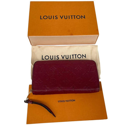 Louis Vuitton black leather wallet with monogram pattern and embossed logo.