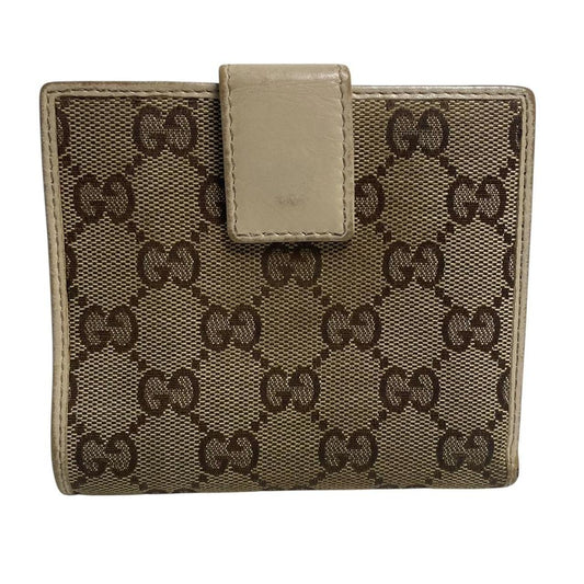Gucci brown bifold wallet with Supreme monogram pattern and leather accents.