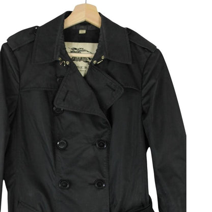 Burberry black double breasted belted trench coat with logo detailing and classic design.