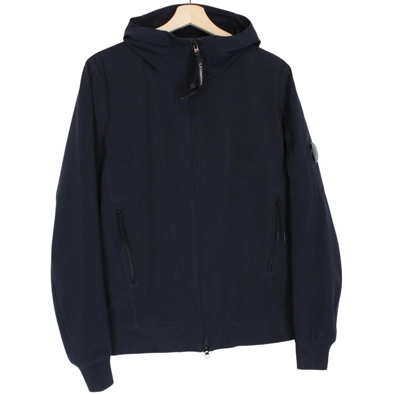 CP Company navy blue goggle jacket with full zip and soft shell material.
