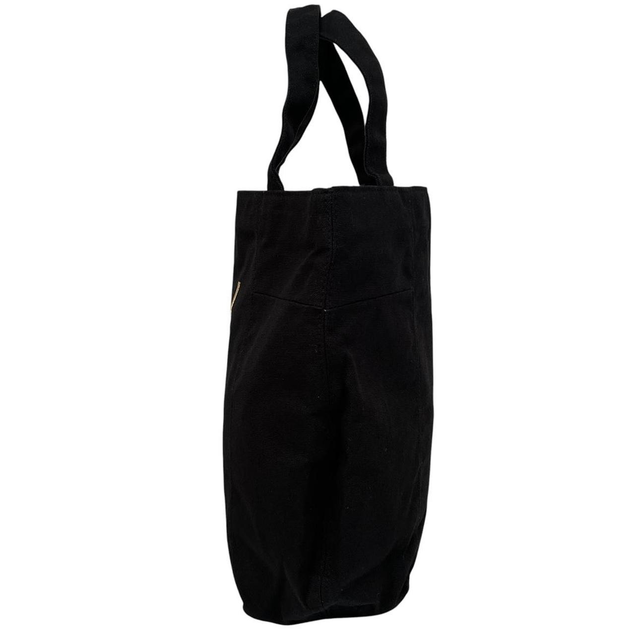 Yves Saint Laurent black duffel bag with gold embroidery and logo detail.