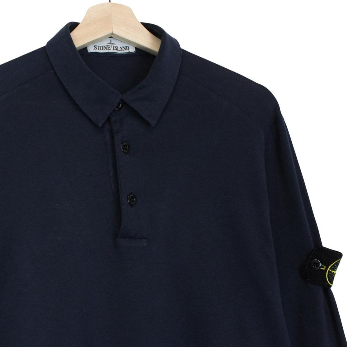 Stone Island navy blue long sleeve polo shirt with iconic compass logo on chest.