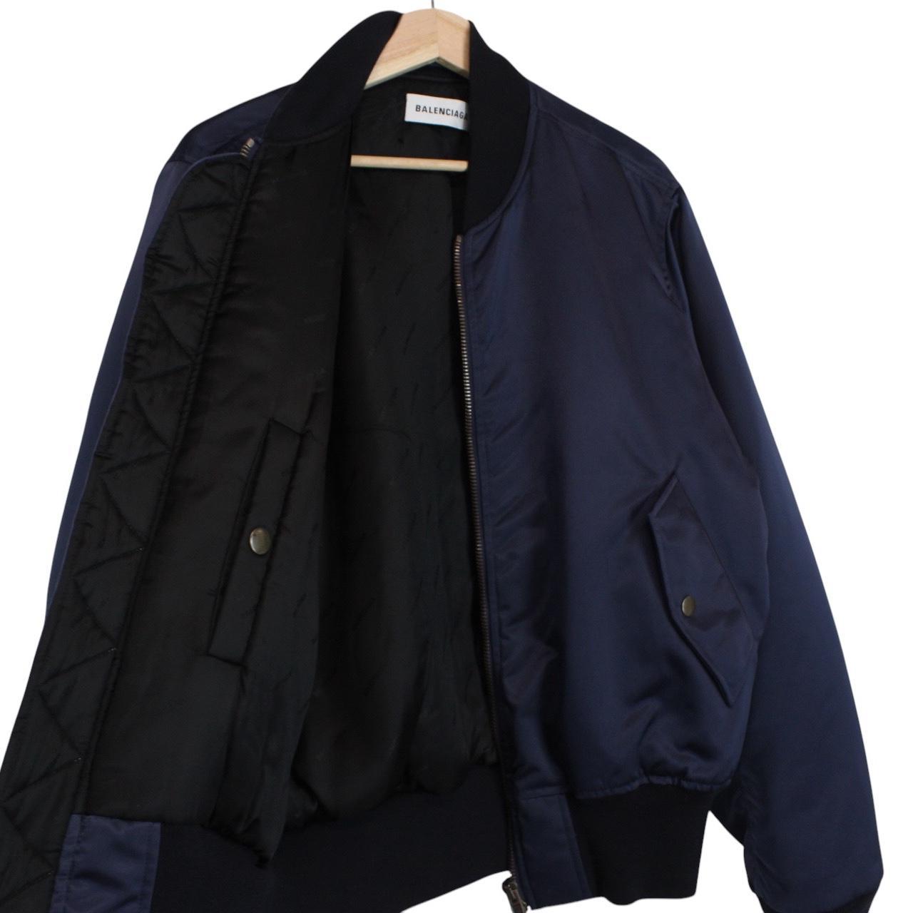 Balenciaga navy bomber jacket with full zip and campaign logo on chest.