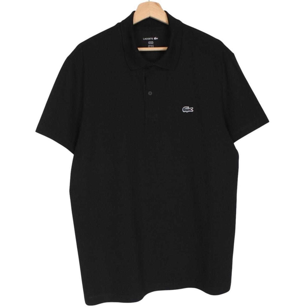 Lacoste black short sleeve polo shirt with embroidered crocodile logo, made of cotton.