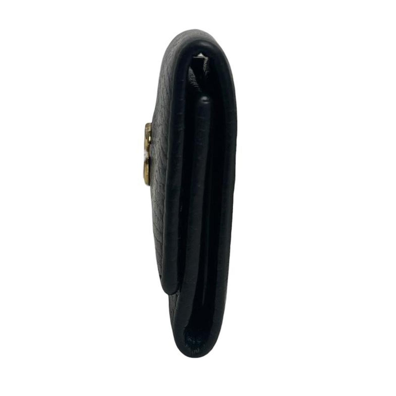 Gucci black leather key case with GG logo and quilted pattern.
