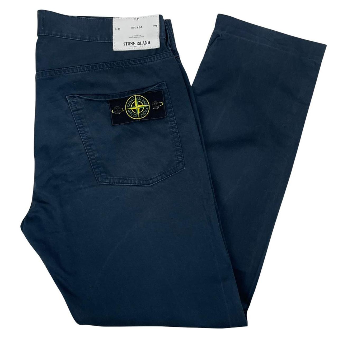 Stone Island navy blue trousers with RE-T fit, cotton material, and iconic compass logo.