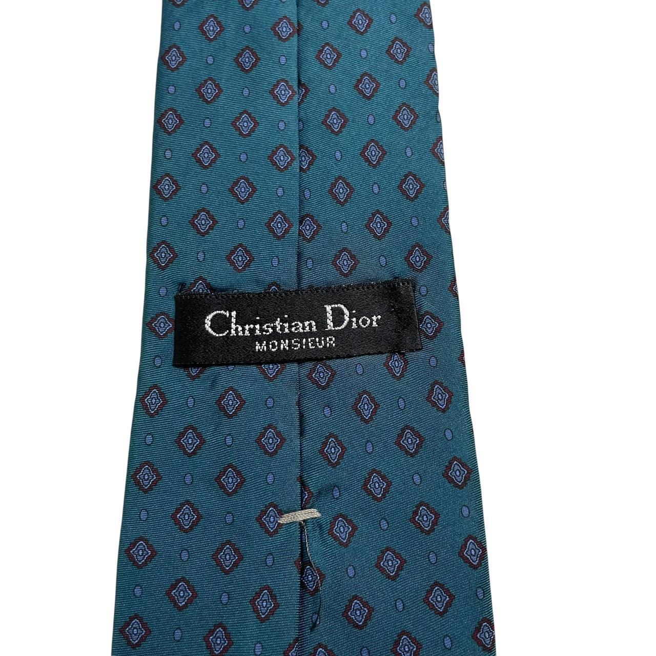 Christian Dior blue silk tie with subtle sheen and classic design.