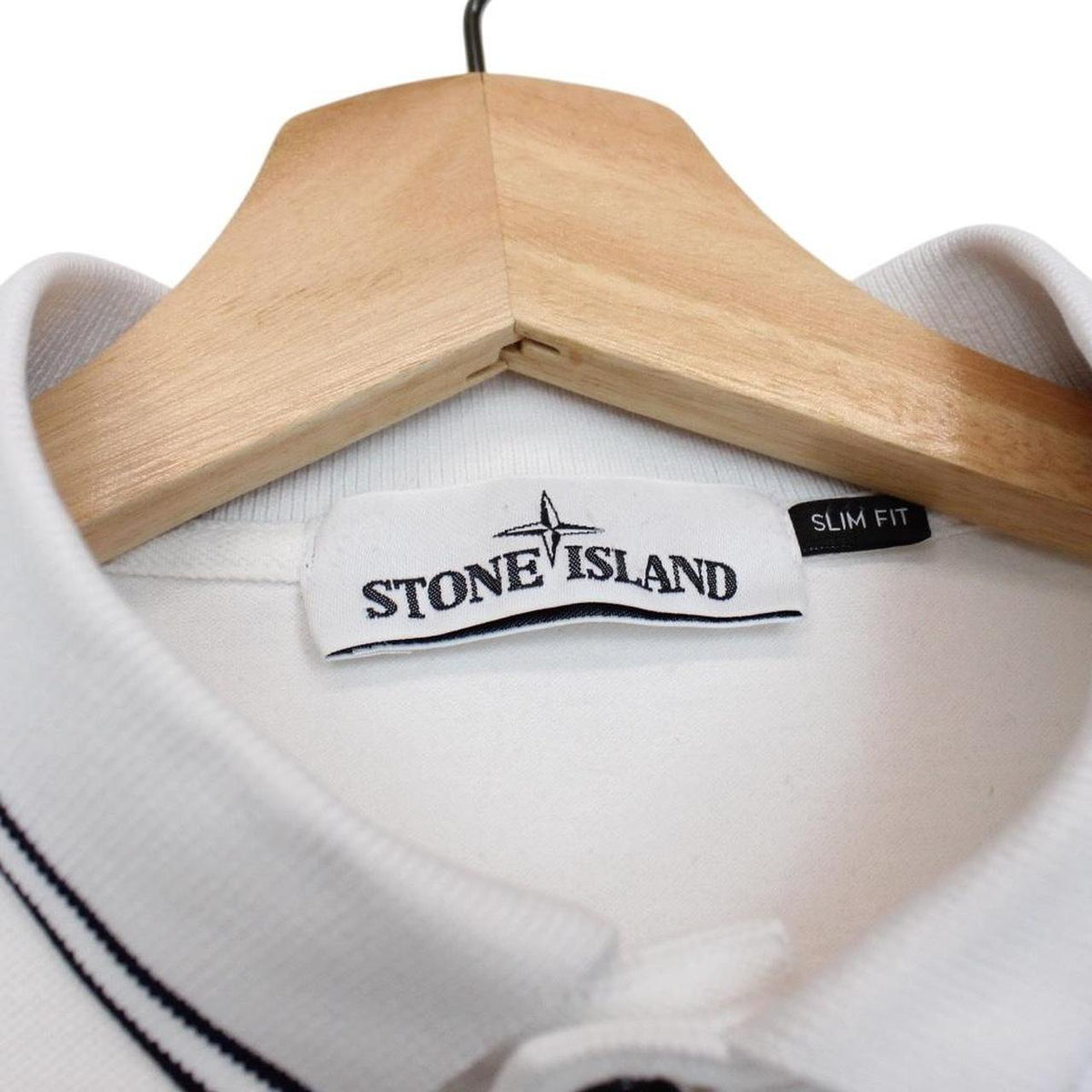 Stone Island white long sleeve polo shirt with compass logo and slim fit design.