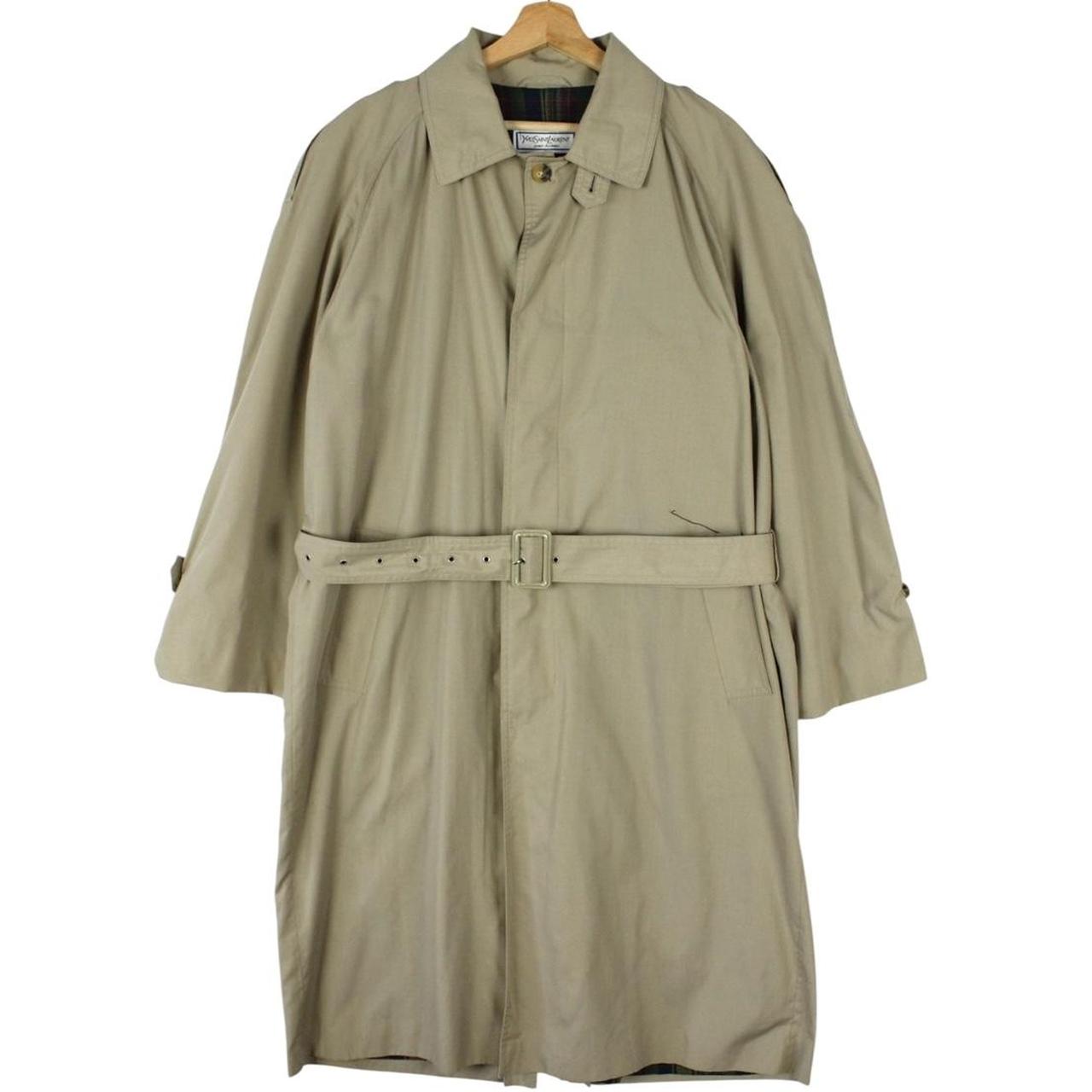 Yves Saint Laurent beige trench coat with single breasted design and belted waist.