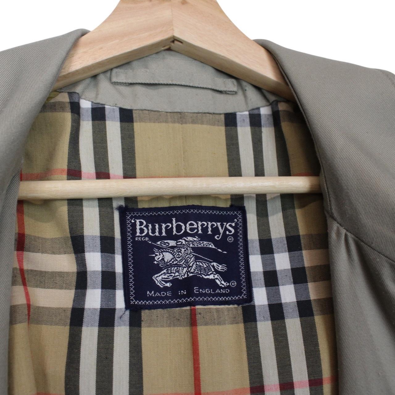 Burberry khaki green trench coat featuring Nova Check pattern and single breasted design.