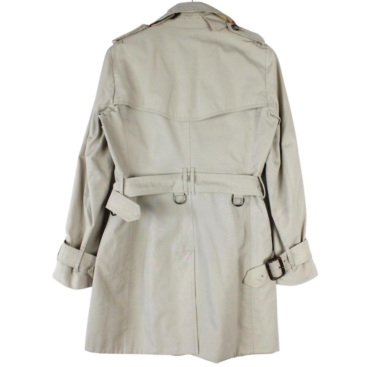 Burberry beige trench coat featuring Nova Check pattern and double-breasted design with belt.