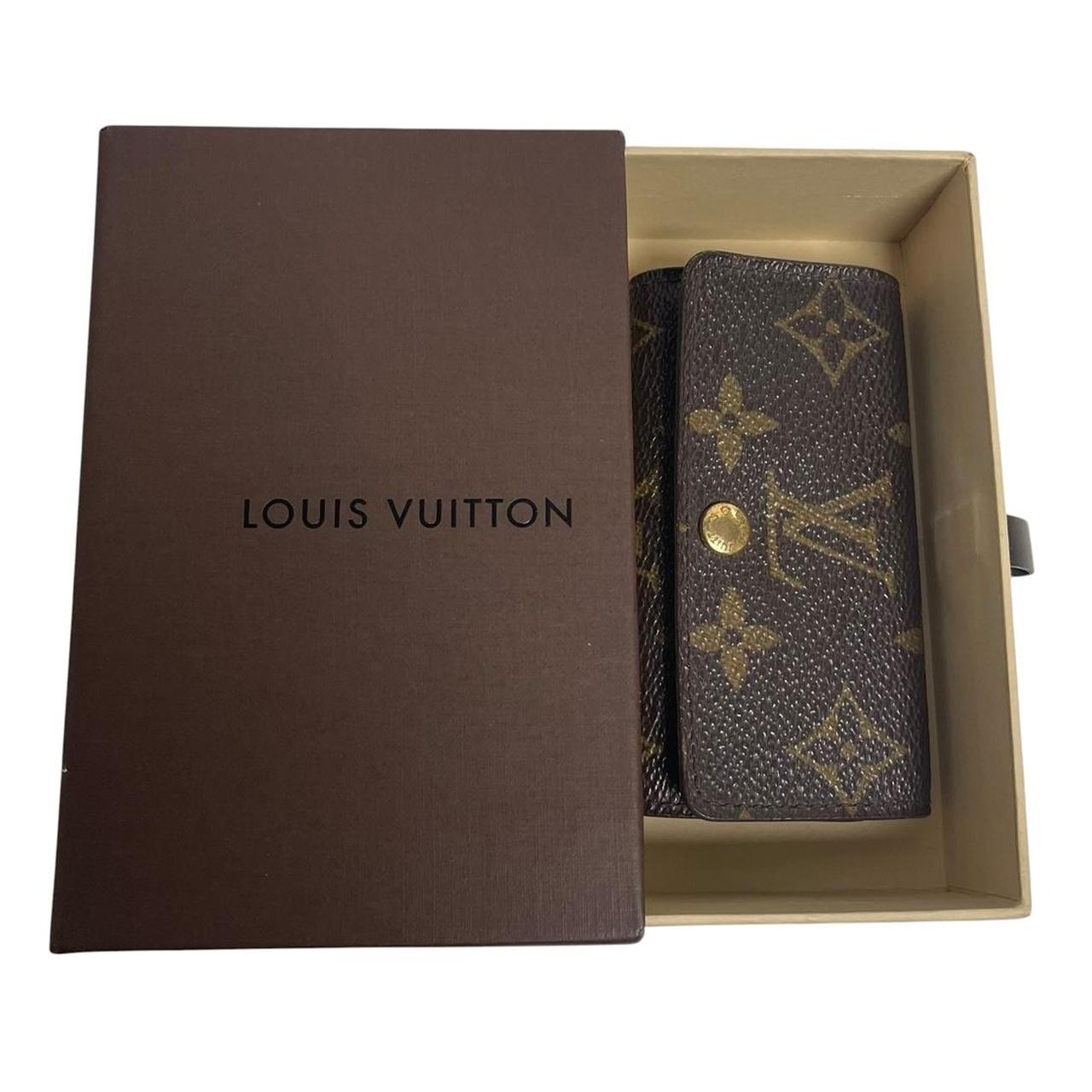 Louis Vuitton brown and tan monogram canvas key case with logo detail.