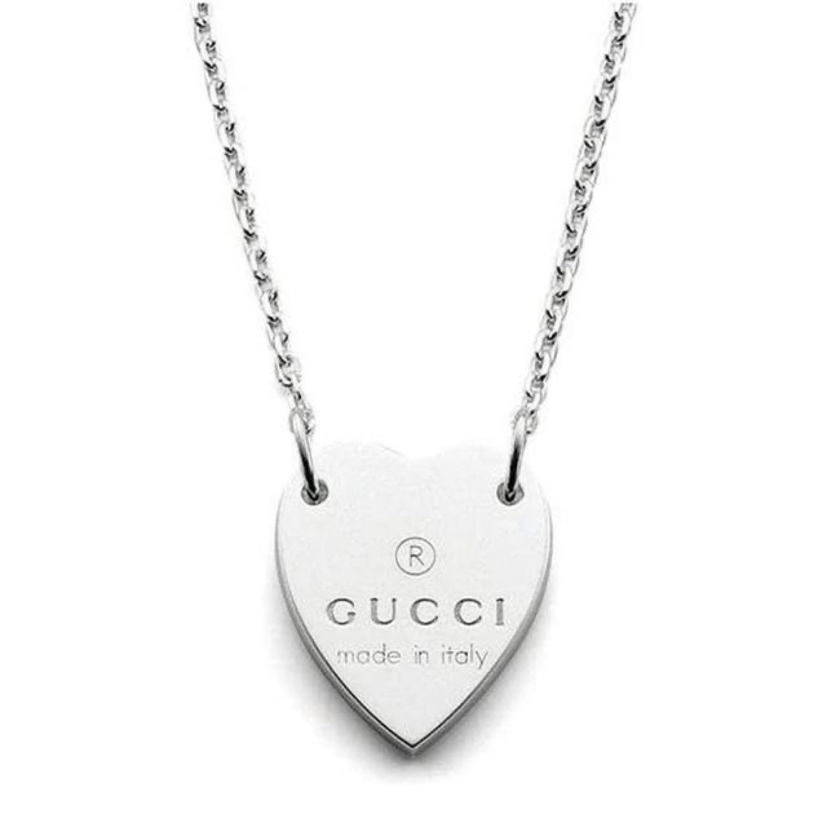 Gucci silver necklace with trademark heart pendant and minor scratches.