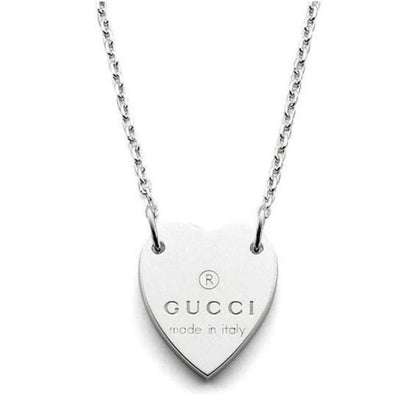 Gucci silver necklace with trademark heart pendant and minor scratches.