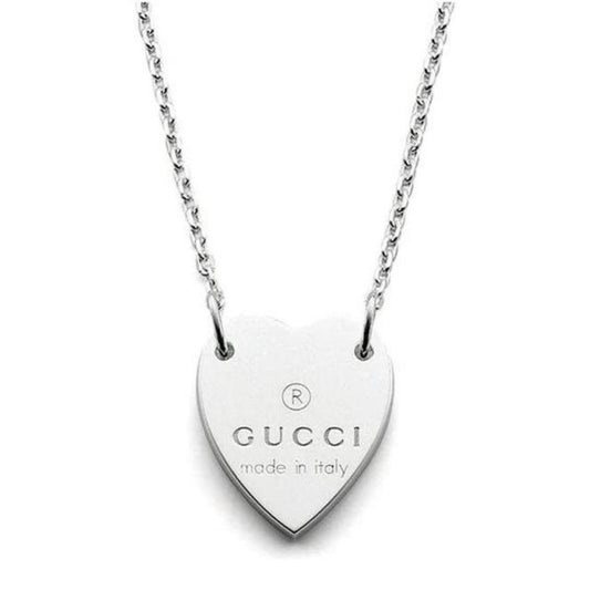 Gucci silver necklace with trademark heart pendant and minor scratches.