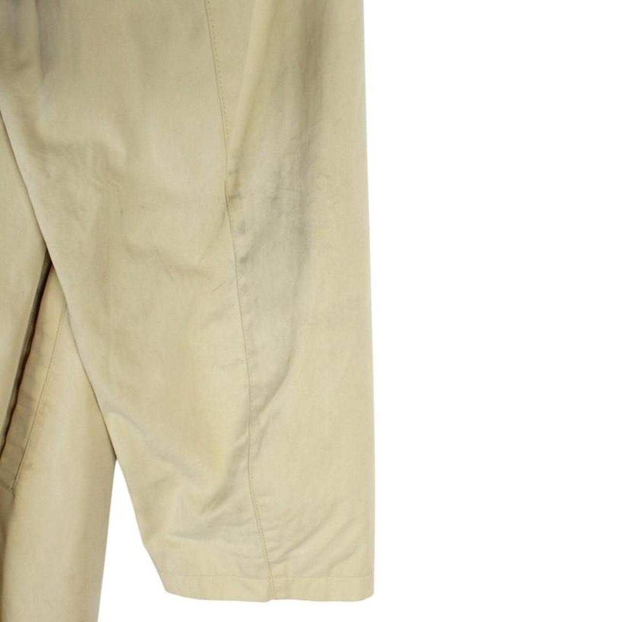 Burberry beige single breasted coat with logo detail and classic tailored design.