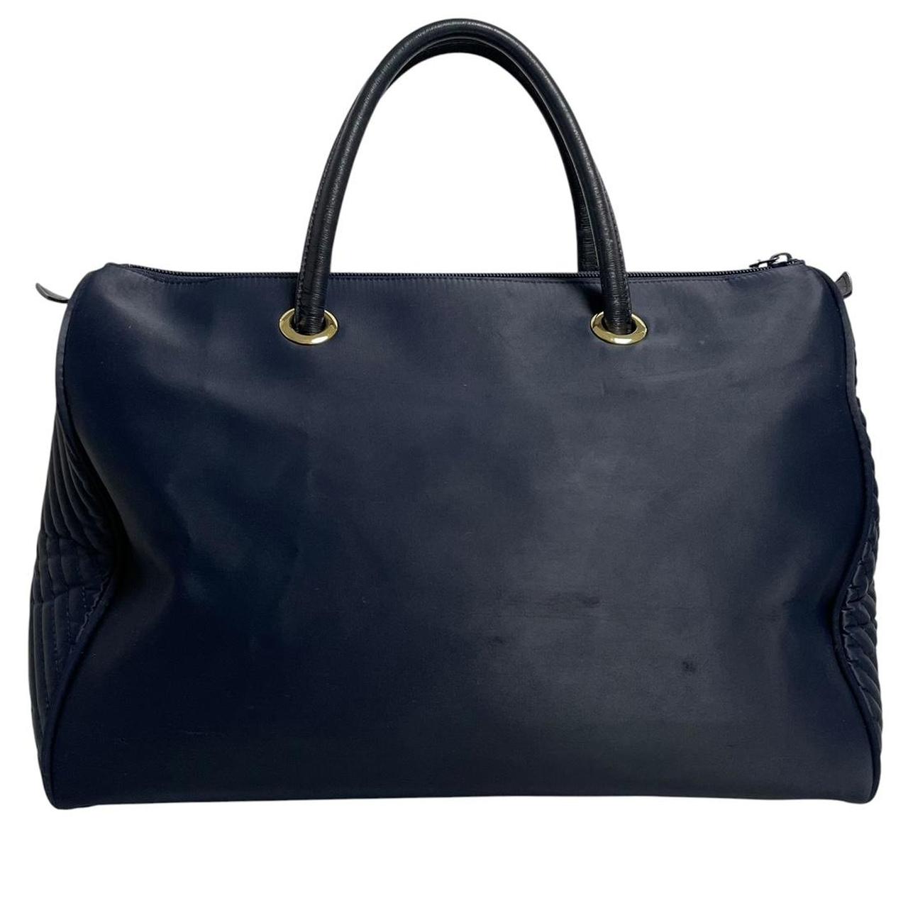 Yves Saint Laurent navy blue duffel bag embossed logo nylon material with handles.