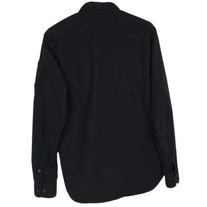 CP Company black button-up jacket with lens detail and cotton material.
