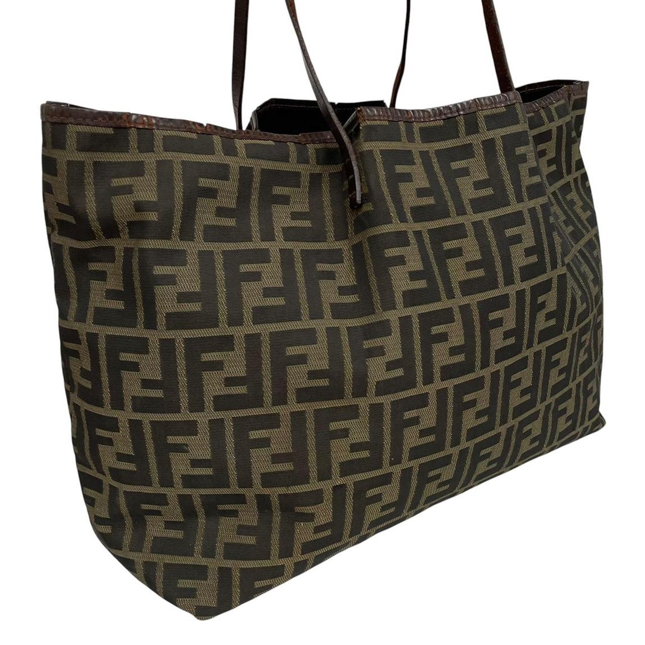 Fendi brown monogram canvas duffel bag with leather trim and logo detail.