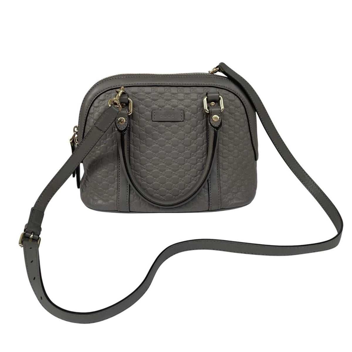 Gucci grey microguccissima mini dome shoulder bag with embossed logo and leather material.
