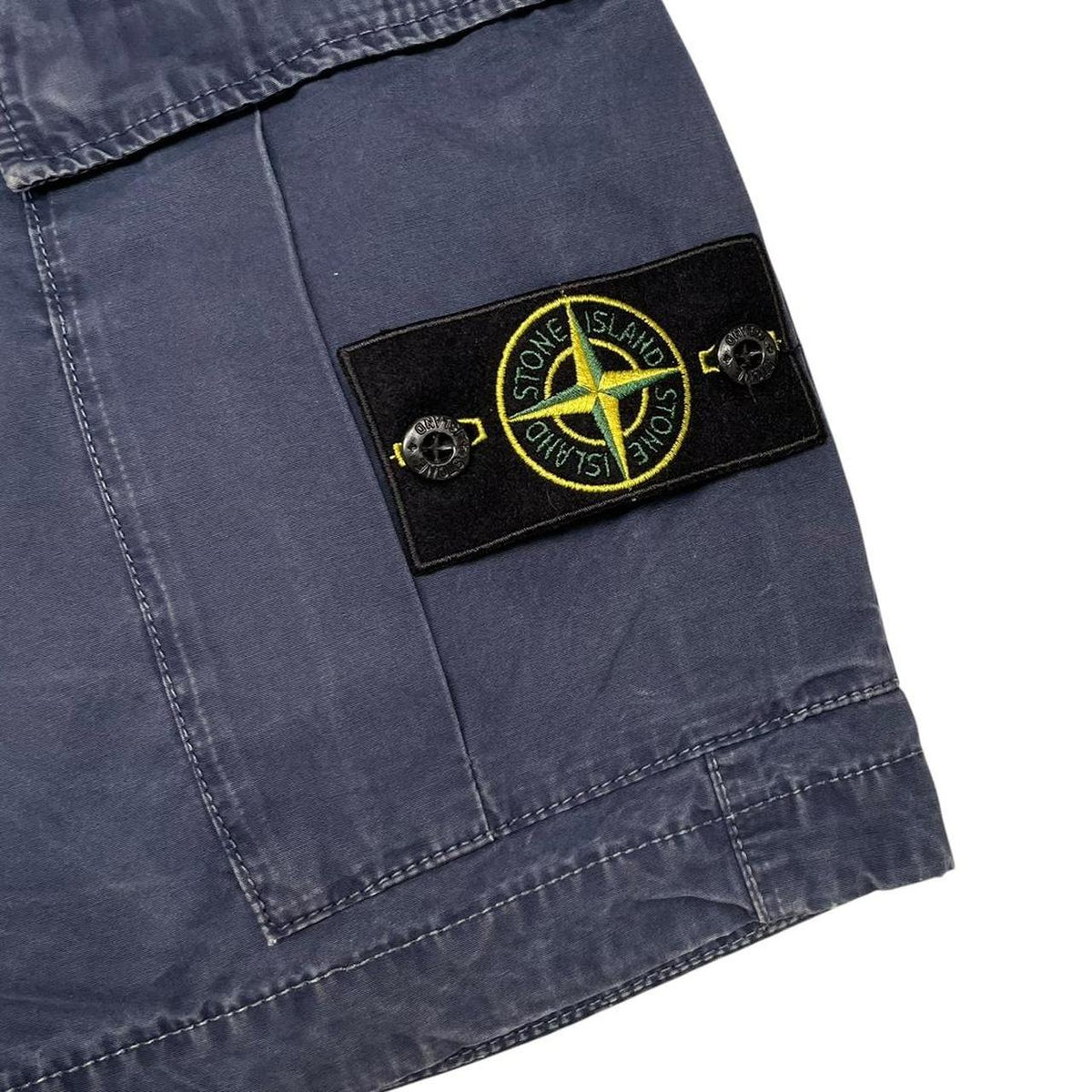 Stone Island navy blue cargo shorts with iconic compass logo and cotton material.