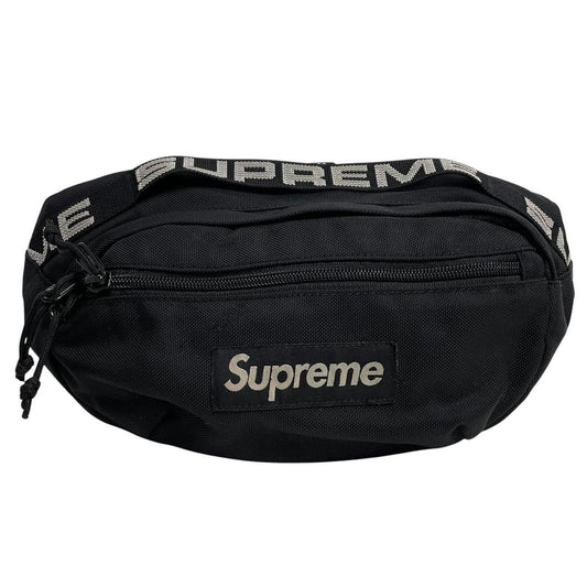 Supreme black waist bag featuring logo print and durable material.