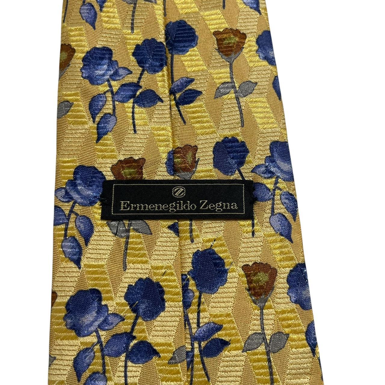 Ermenegildo Zegna yellow silk tie with floral pattern and logo detail.