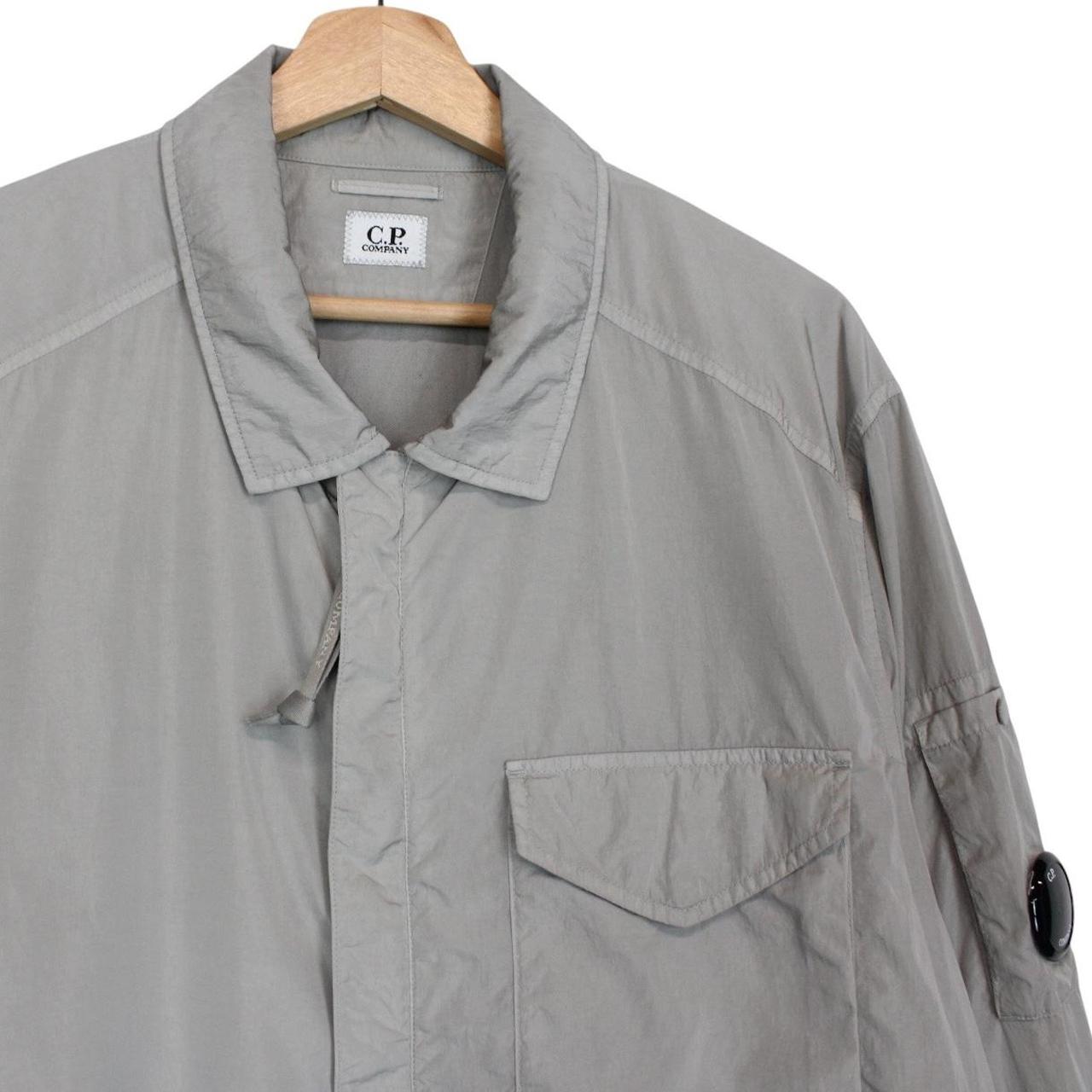 CP Company grey overshirt jacket with lens detail and garment dyed nylon fabric.