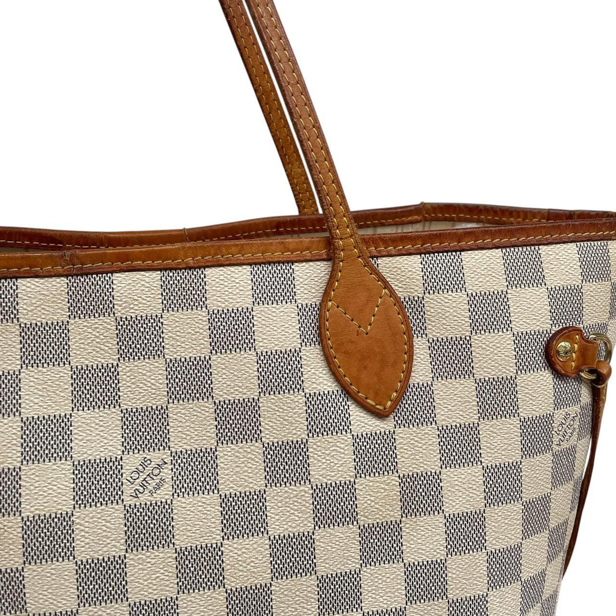 Louis Vuitton cream Damier Azur tote bag with leather trim and logo pattern.