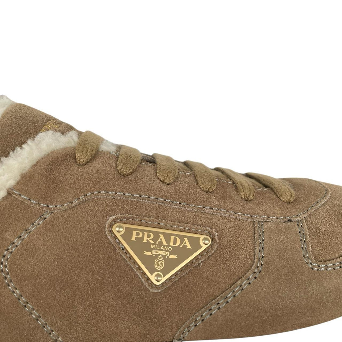 Prada brown suede trainers with shearling lining and logo detail.