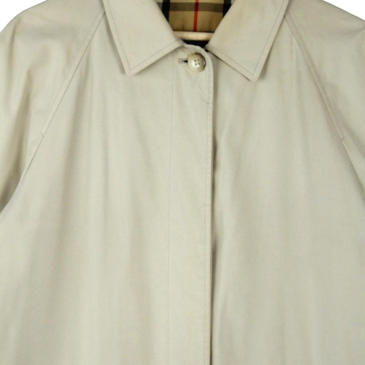 Burberry beige trench coat featuring iconic Nova Check pattern and single breasted design.