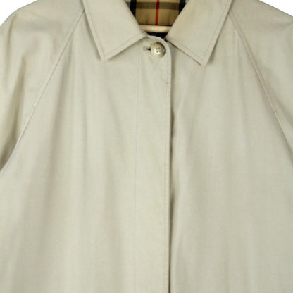 Burberry beige trench coat featuring iconic Nova Check pattern and single breasted design.