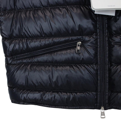 Moncler navy blue down gilet with logo patch and quilted design.
