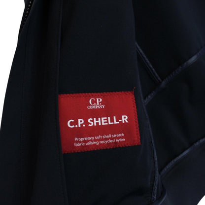 CP Company navy blue goggle jacket with full zip and soft shell material.