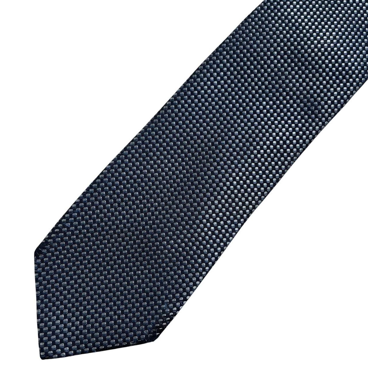 Hugo Boss blue silk tie with white polka dots and logo detail.