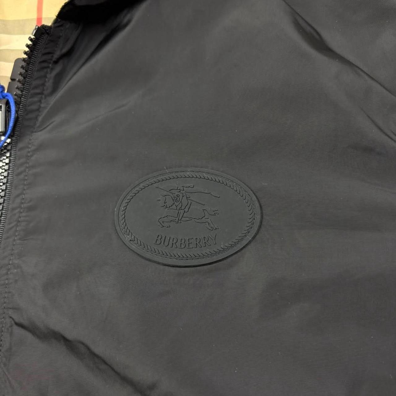 Burberry reversible windbreaker jacket in sand beige and black Nova Check pattern.