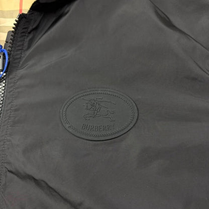 Burberry reversible windbreaker jacket in sand beige and black Nova Check pattern.