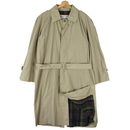 Yves Saint Laurent beige trench coat with single breasted design and belted waist.