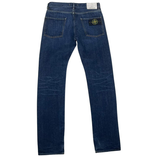 Stone Island navy blue straight jeans with logo patch and visible scuff on left knee.