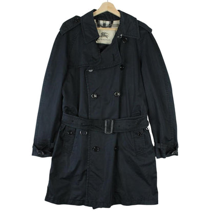Burberry beige double breasted belted trench coat with classic check lining and logo detail.