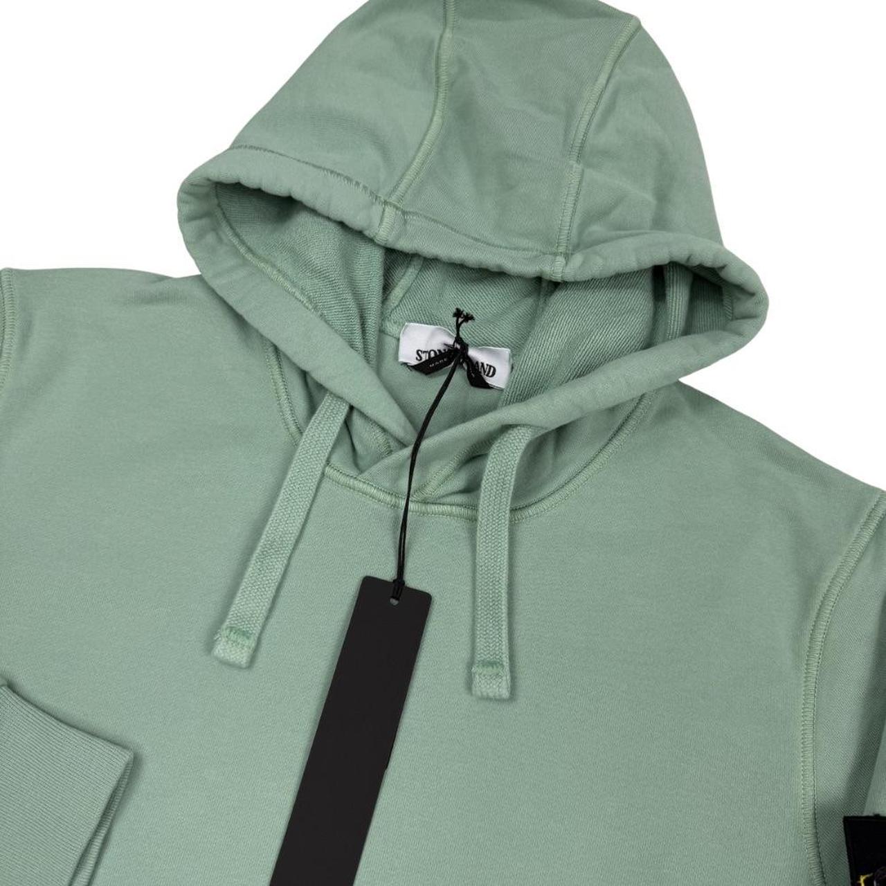 Stone Island green cotton hoodie with logo patch and drawstring hood.