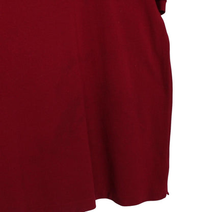 Lacoste burgundy polo shirt with embroidered crocodile logo and pocket detail.