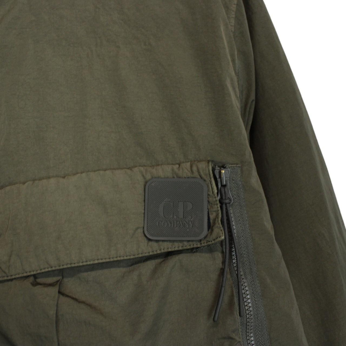 CP Company green hooded jacket with chrome detailing and logo patch on sleeve.
