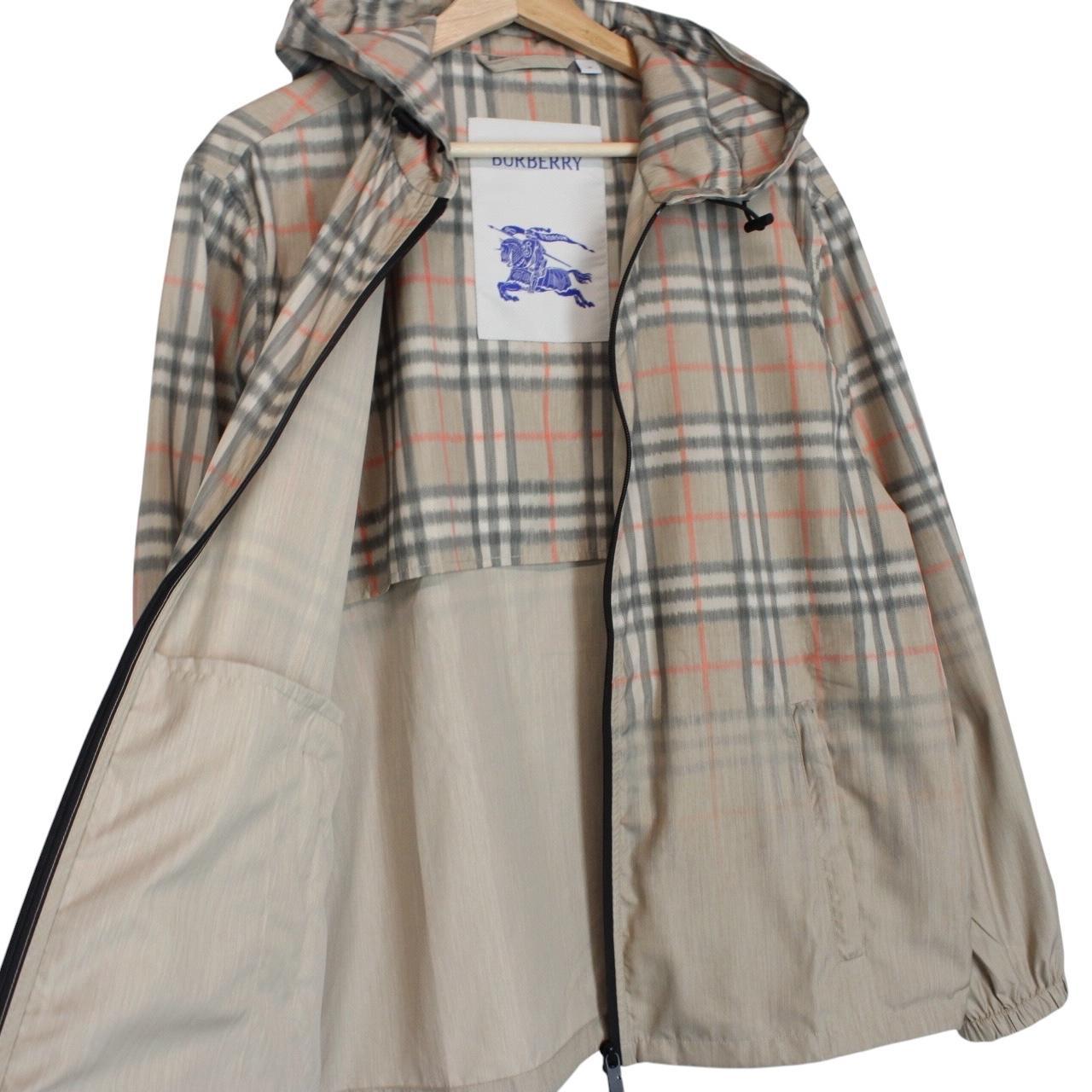 Burberry beige windbreaker jacket with Nova Check pattern and full zip hood.