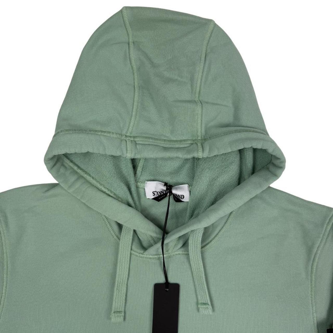 Stone Island green cotton hoodie with logo patch and drawstring hood.