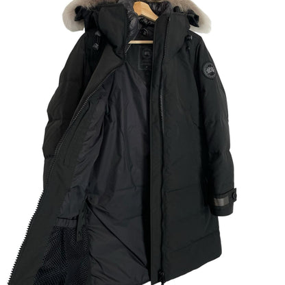 Canada Goose black parka with fur trim, logo patch, and down insulation.