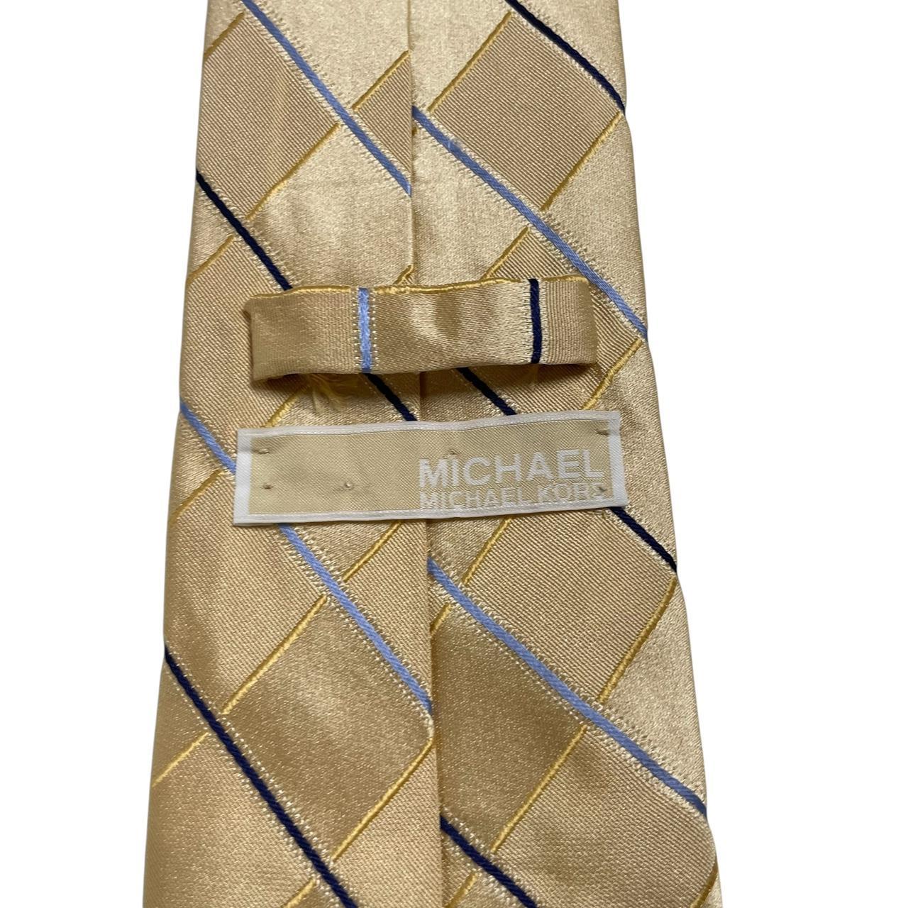 Michael Kors gold silk tie with striped pattern and logo detail.
