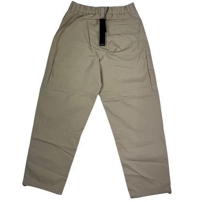 Stone Island beige cargo trousers with logo patch and multiple pockets.